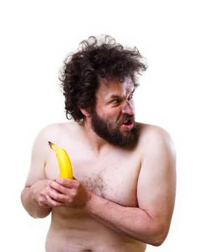 Wild man looking confused at a banana Stock Photos