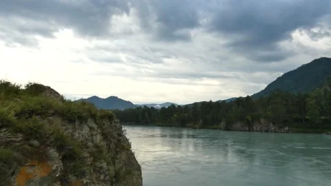 Wild mountain river. Fast water stream, hills and trees behind. Cloudy day. Stock Footage 159052028