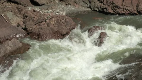 Wild mountain river flowing with stone boulders and stone rapids. Slow Motion Stock-Footage 203770816