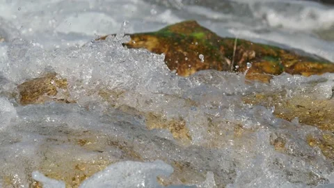 Wild mountain river flowing through stone boulders. Abundant clear stream in  Stock Footage 172453195