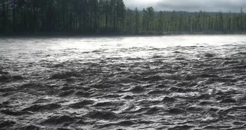 Wild mountain river flowing through stone boulders. Abundant clear stream in Stock Footage 232942343