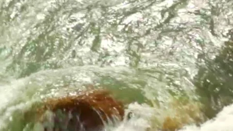 Wild mountain river flowing through stone boulders, Water clear stream river flo Stock Footage 244999975