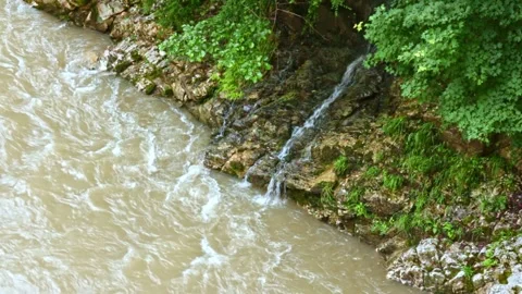 Wild mountain river flowing through stone boulders, Water clear stream river flo Stock Footage 245022209