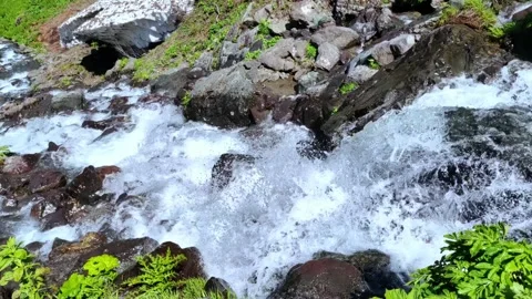 Wild mountain river flowing through stone boulders. Water background concept. Stock Footage 285653091