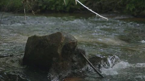 Wild mountain river flowing through stone boulders. Slow motion Mountain ri.. Video stock 330798811
