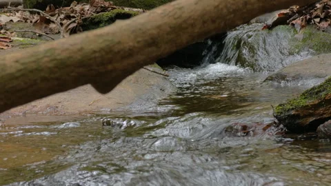 Wild mountain river flowing through stone boulders. Slow motion Mountain ri.. Video stock 330884233