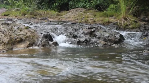 Wild mountain river flows through large rocks. Abundant clear water flow. Stock Footage 277282430