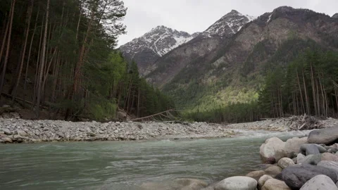 Wild mountain river running through stone rapids in Elbrus Stock Footage 197112648