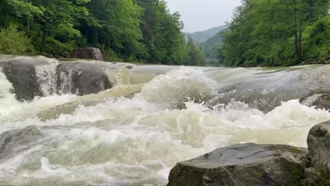 Wild mountain river running through stone rapids in carpathians in slow motion Stock Footage 249874371