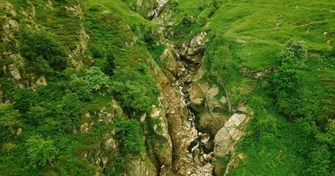 Wild mountain stream carves between rocks Stock Footage 94206798