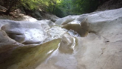 A wild mountain stream flows along a stone bed. The Grand Canyon of Crimea.  Video stock 163205616