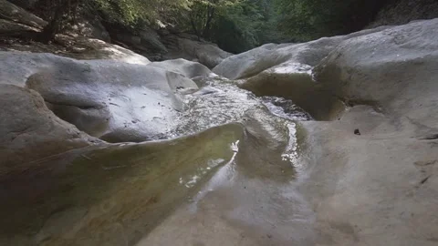 A wild mountain stream flows along a stone bed. The Grand Canyon of Crimea. Video stock 165362514
