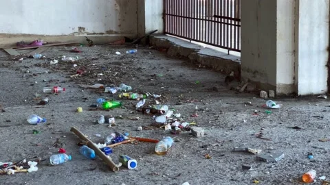 A wild mouse searching for food within the trash inside an abandoned garage Stock Footage 227350649