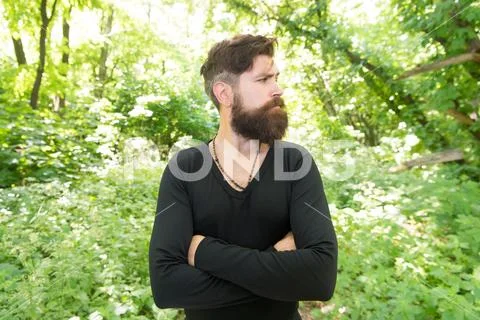 Wild nature. Man bearded hipster bright foliage background. Guy relax in forest Stock Photos