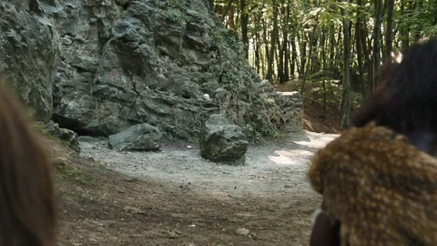 Wild neanderthals hunting in group chasing large mammoth for animal prey in Stock Footage 116634400