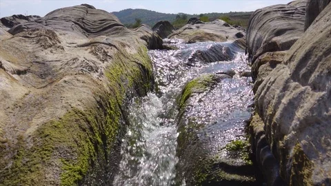 Wild river between the rocks forms a beautiful natural falling waterfall Stock Footage 115444731