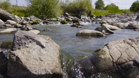 Wild river between the stones forms a beautiful natural waterfall stream Stock Footage 115444364