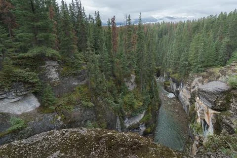 Wild river flows swiftly between steep cliffs of Maligne Canyon in Jasper Stock Photos