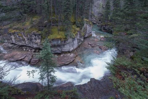 Wild river flows swiftly between steep cliffs of Maligne Canyon in Jasper Stock Photos