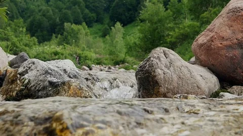 A wild river high in the mountains Видео 80558403