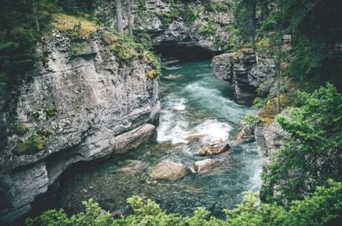 Wild river stream among cliffs and rocks Stock Photos