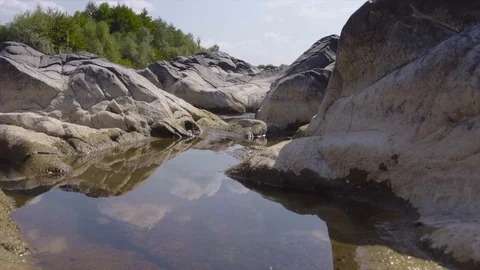 Wild river stream flows between the stones in sunny beautiful nature Stock Footage 115445543