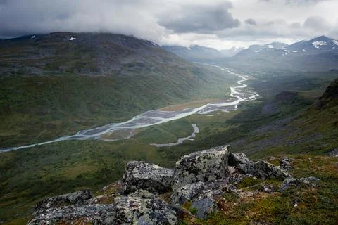 Wild river winds through remote arctic valley on a cloudy, rainy day of arctic Stock Photos