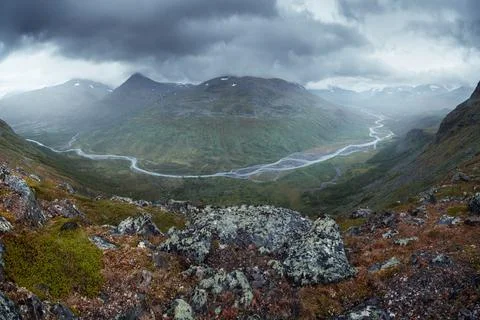 Wild river winds through remote arctic valley on a cloudy, rainy day of arctic Stock Photos