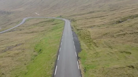 Wild road between huge green hills in the Faroe Island Video stock 237713702