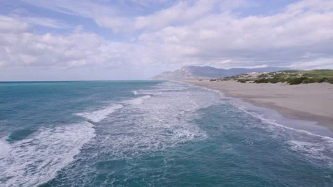 Wild sandy beach. Flying a quadrocopter over the waves. Stock Footage 169044165