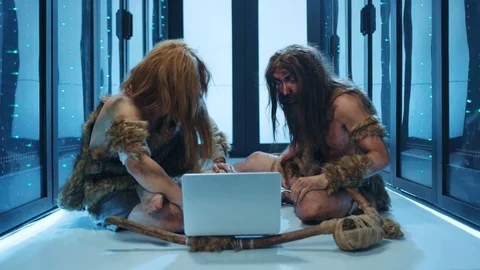 Wild savages using laptop computer in digital server room. Primitive cavemen Stock Footage 120748445