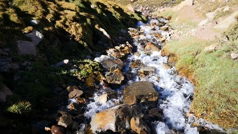 A wild scenery inside Andes mountains with a waterfall carrying melting water Stockbeeldmateriaal 106909787