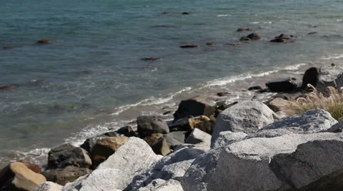 Wild stone shore or coast with waves of the Pacific ocean on Malibu, California Stock Footage 54977952