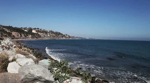 Wild stone shore or coast with waves of the Pacific ocean on Malibu, California Stock Footage 54978418
