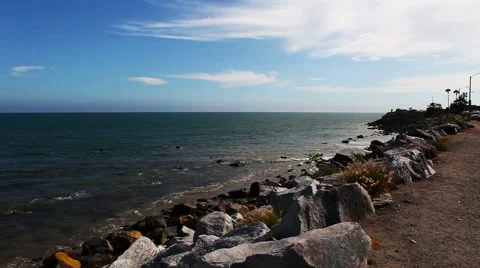 Wild stone shore or coast with waves of the Pacific ocean on Malibu, California Stock Footage 54978548