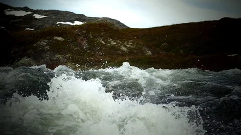 Wild stream flows over a rocky slope. Slow motion footage. Vídeo Stock 81727405
