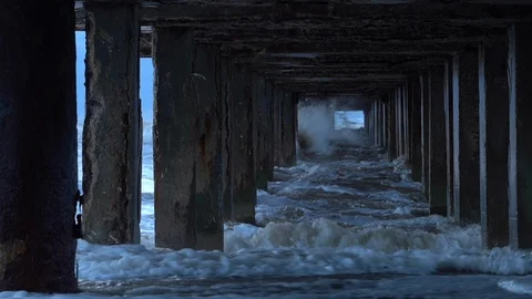 Wild waves are splashing and hitting piles of the pier at the Black Sea coast. Stock Footage 127256035