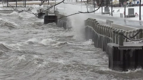 Wild waves breaking crashing into shore in hurricane force wind storm Stock Footage 147630548