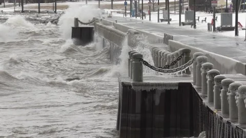 Wild waves breaking crashing into shore in hurricane force wind storm Stock Footage 147639302