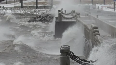 Wild waves breaking crashing into shore in hurricane force wind storm Видео 147640818