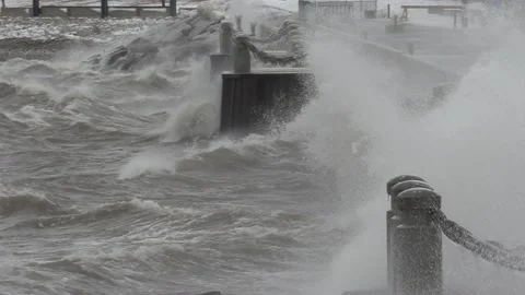 Wild waves breaking crashing into shore in hurricane force wind storm Stockbeeldmateriaal 147641418