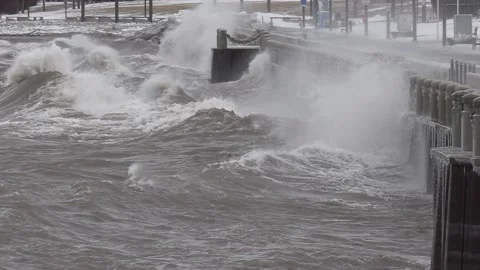 Wild waves breaking crashing into shore in hurricane force wind storm Видео 147642387
