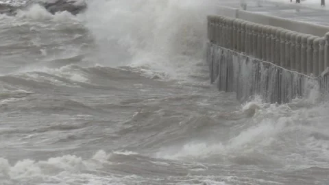 Wild waves breaking crashing into shore in hurricane force wind storm 動画素材 147643625
