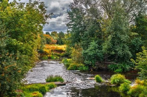 Wild wilderness landscape showcasing dynamic water movement, vibrant autumn t Stock Photos