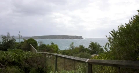 Wild winds and rough waves smash on the cliffs of sydney coast in slow motio Stock Footage 137624122