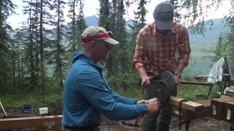 Wilderness Men Sharpening Axe With Hand Grinder Stock Footage 250291723
