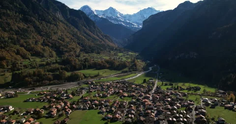 Wilderswil drone shot with Eiger, Mönch, Jungfrau and train passing - Aerial 4K Stock Footage 220894780