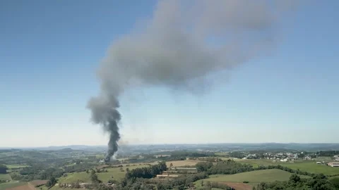 A wildfire in a field with smoke rising high in the sky. Aerial. 4K. Drone. Video stock 330982129