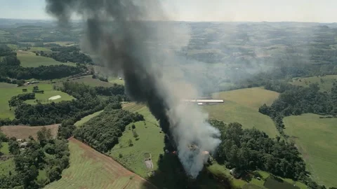 A wildfire in a field with smoke rising high in the sky. Aerial. 4K. Drone. Stock Footage 330982139