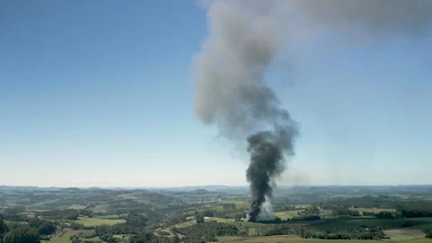A wildfire in a field with smoke rising high in the sky. Aerial. 4K. Drone. Stock Footage 330982170
